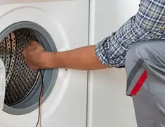 Dryer repair technician diagnosing and servicing a clothes dryer in Detroit, MI