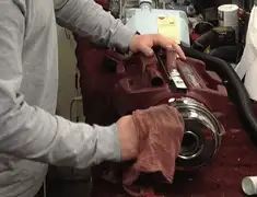 Vacuum repair technician cleaning and servicing a vacuum motor in Detroit, MI